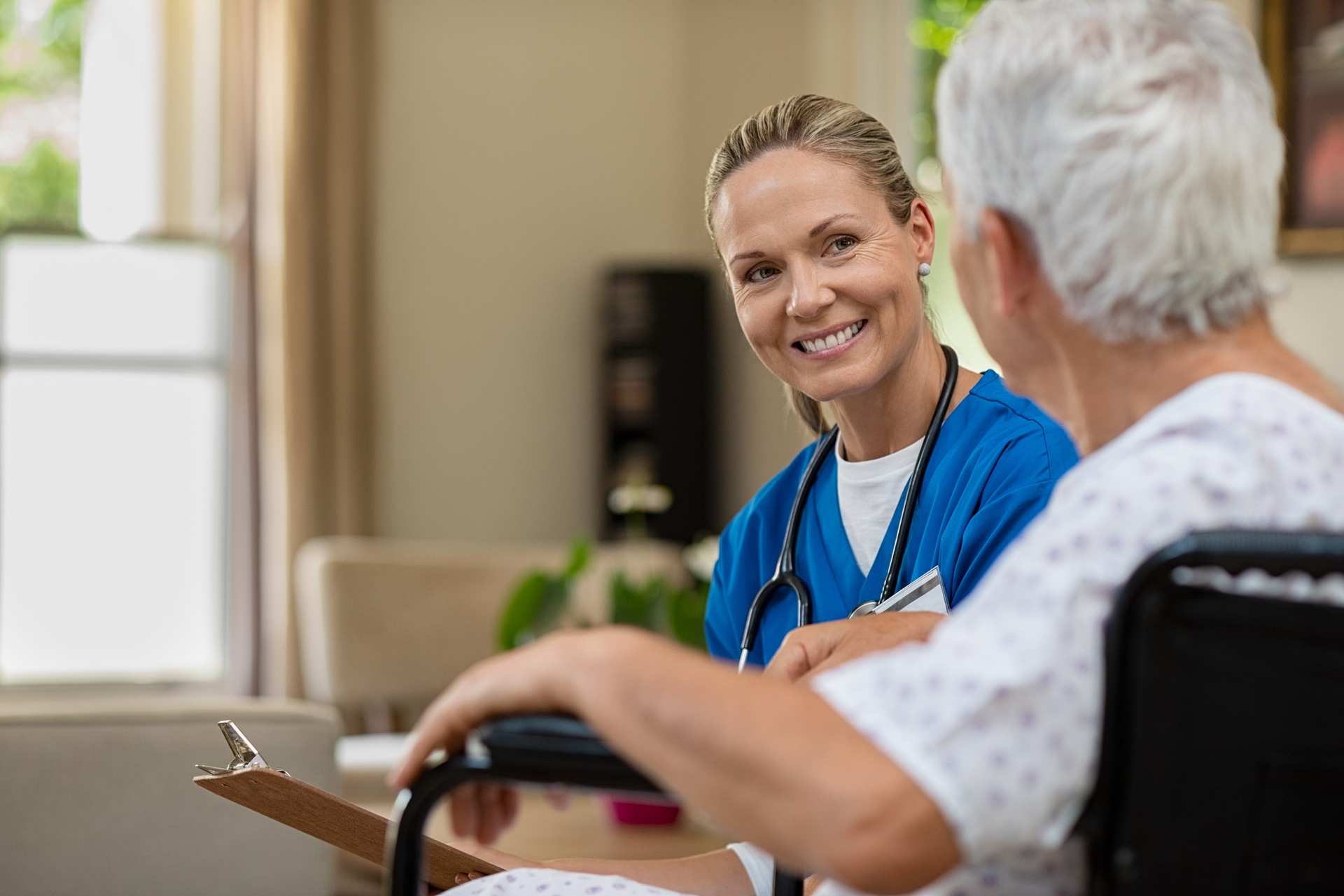 Skilled Nursing Caregiver Consulting with a Senior Patient During Rehab Care in Weatherford, TX
